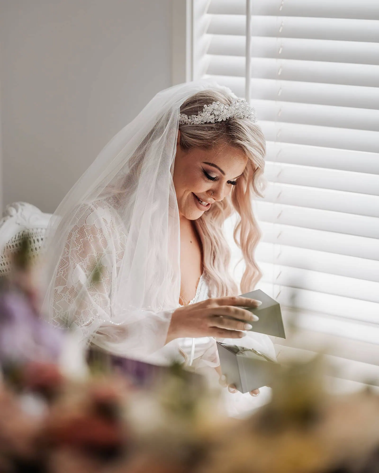 silvestris of clarendon wedding - sam & wayne 196 Bride joyfully opening wedding gift at bridal shower.