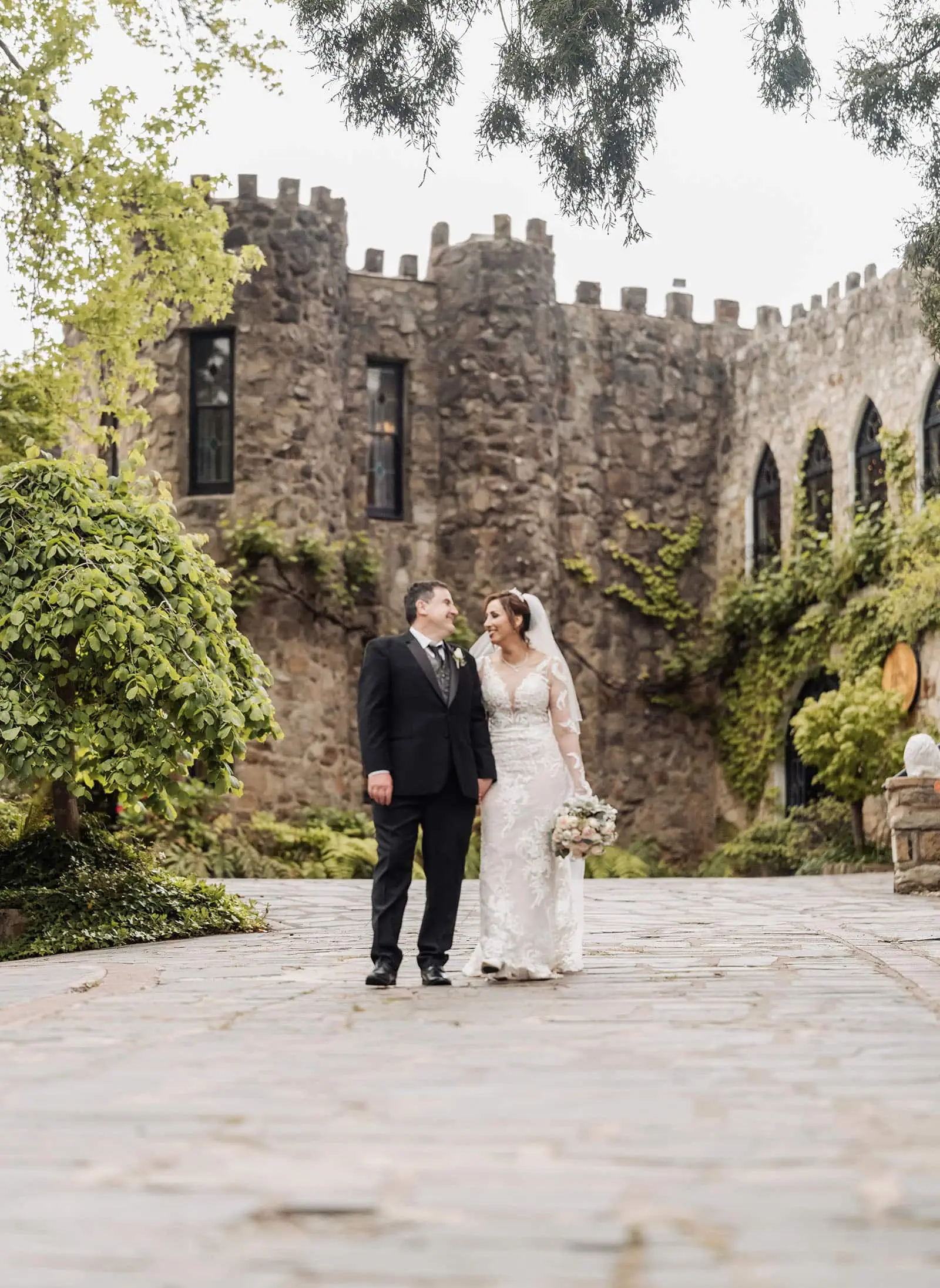 wedding at the manor in basket range - maryam & jason 157 Romantic castle wedding with couple in elegant attire surrounded by enchanting scenery.