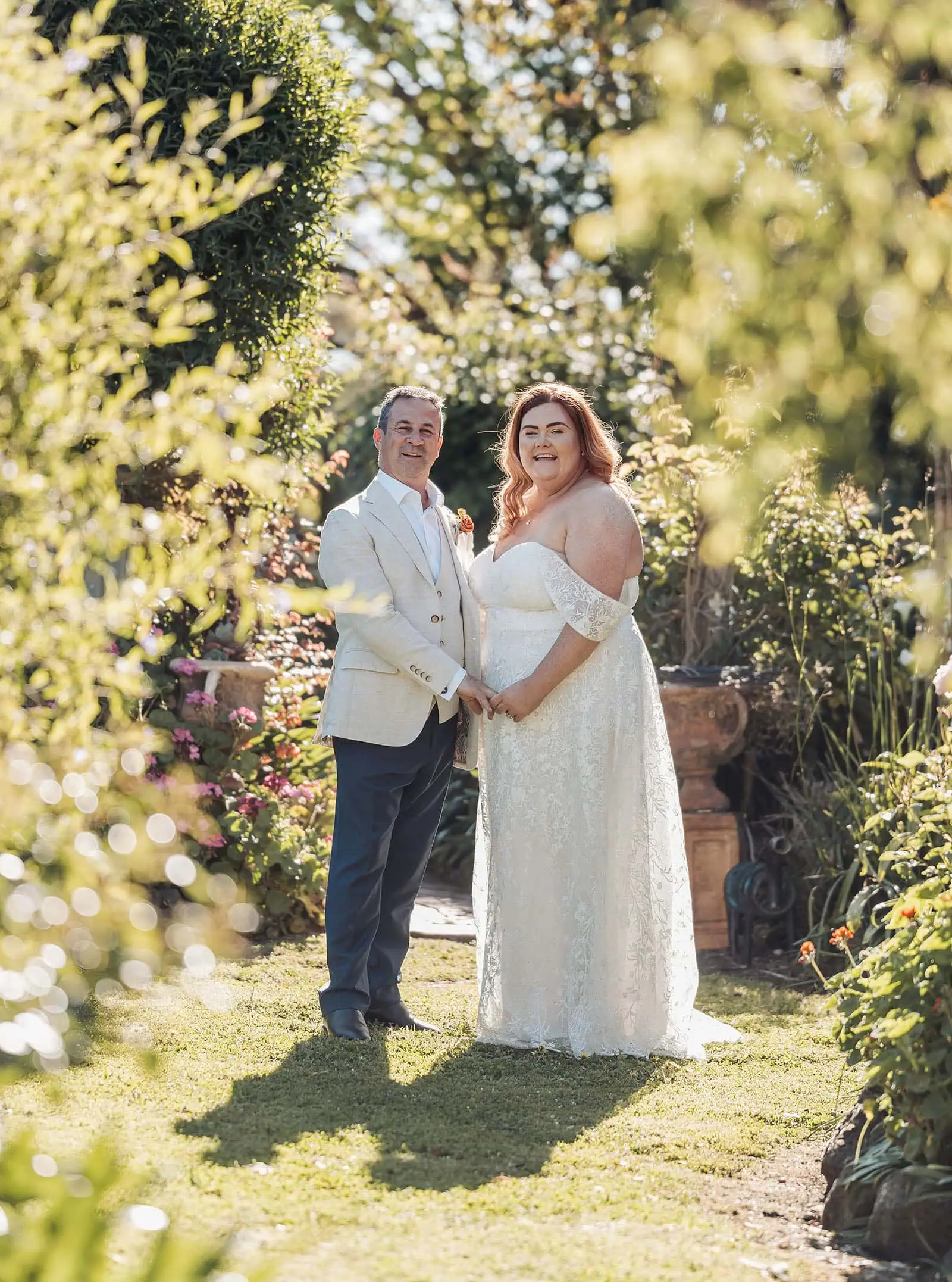 country victoria wedding in corrunnun – rachelle & anthony 337 Couple celebrating in garden, outdoor party, joyful moments, nature setting.