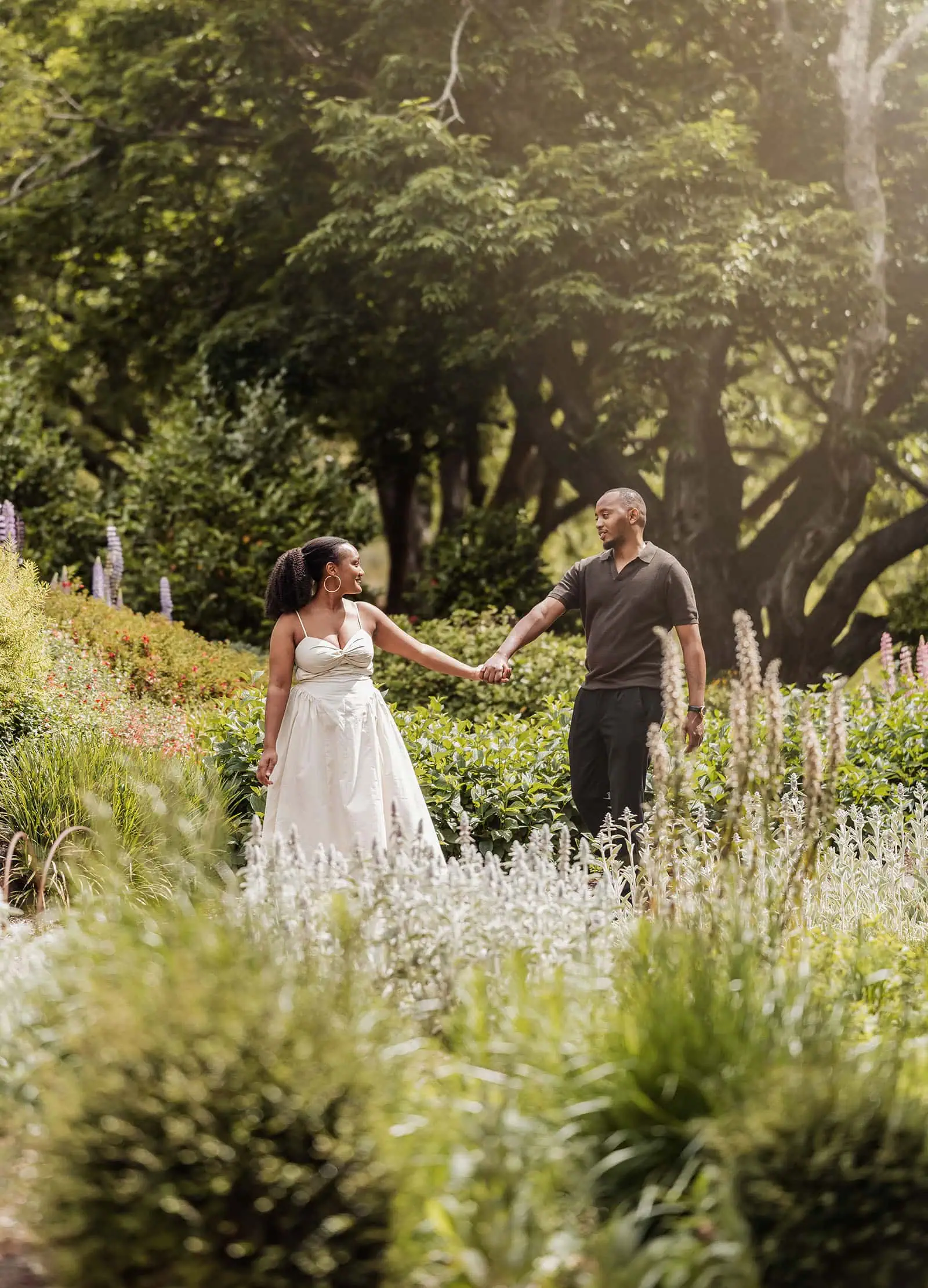mt lofty botanic gardens couples shoot – ruth & emanuel 10 Couple enjoying a lush garden stroll on a sunny day.
