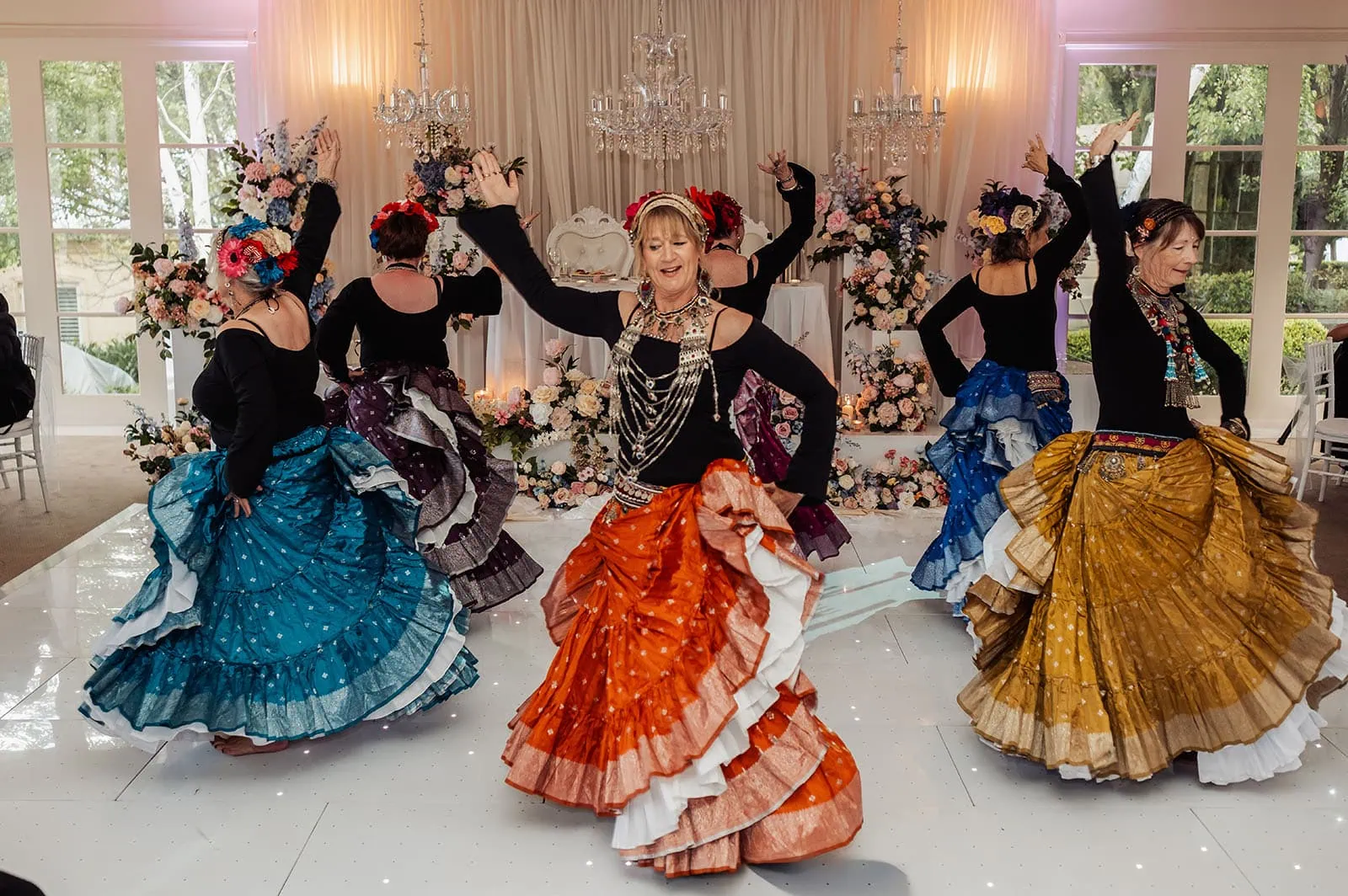 silvestris of clarendon wedding - sam & wayne 252 Group dance performance at cultural celebration, vibrant costumes and joyful expressions.