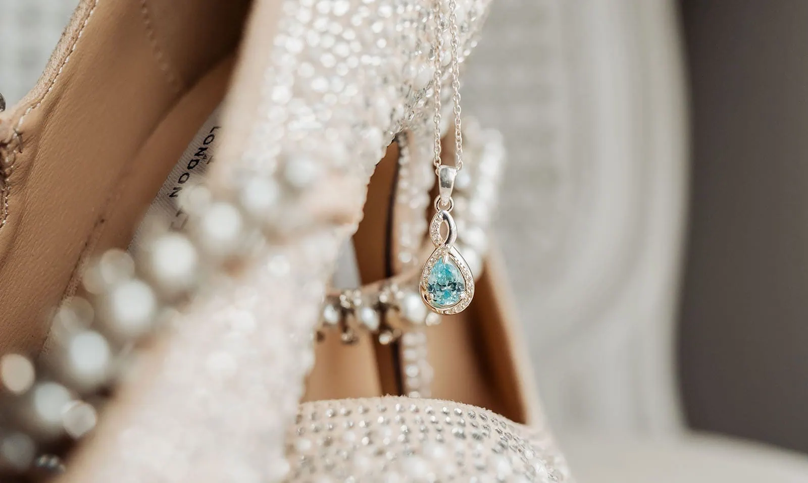 silvestris of clarendon wedding - sam & wayne 195 Elegant pendant and stylish shoe close-up for fashion enthusiasts.