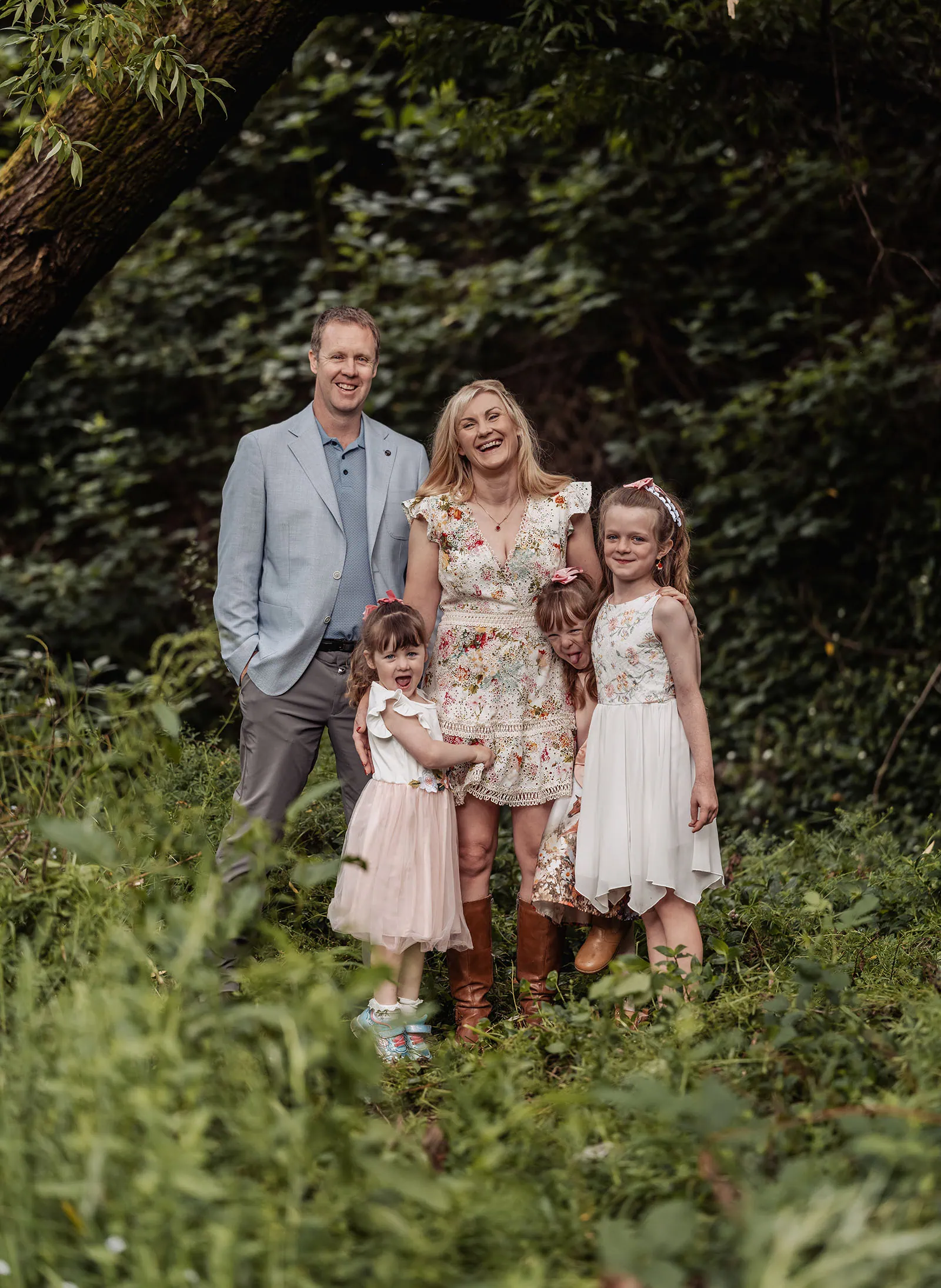 ironbank family photography 116 Happy family in lush forest setting, celebrating with joy and connection.