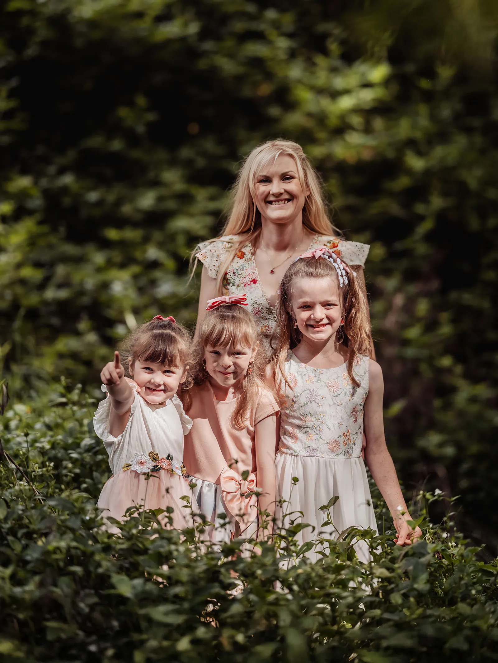 ironbank family photography 125 Family enjoying nature with smiles, floral dresses, lush greenery.
