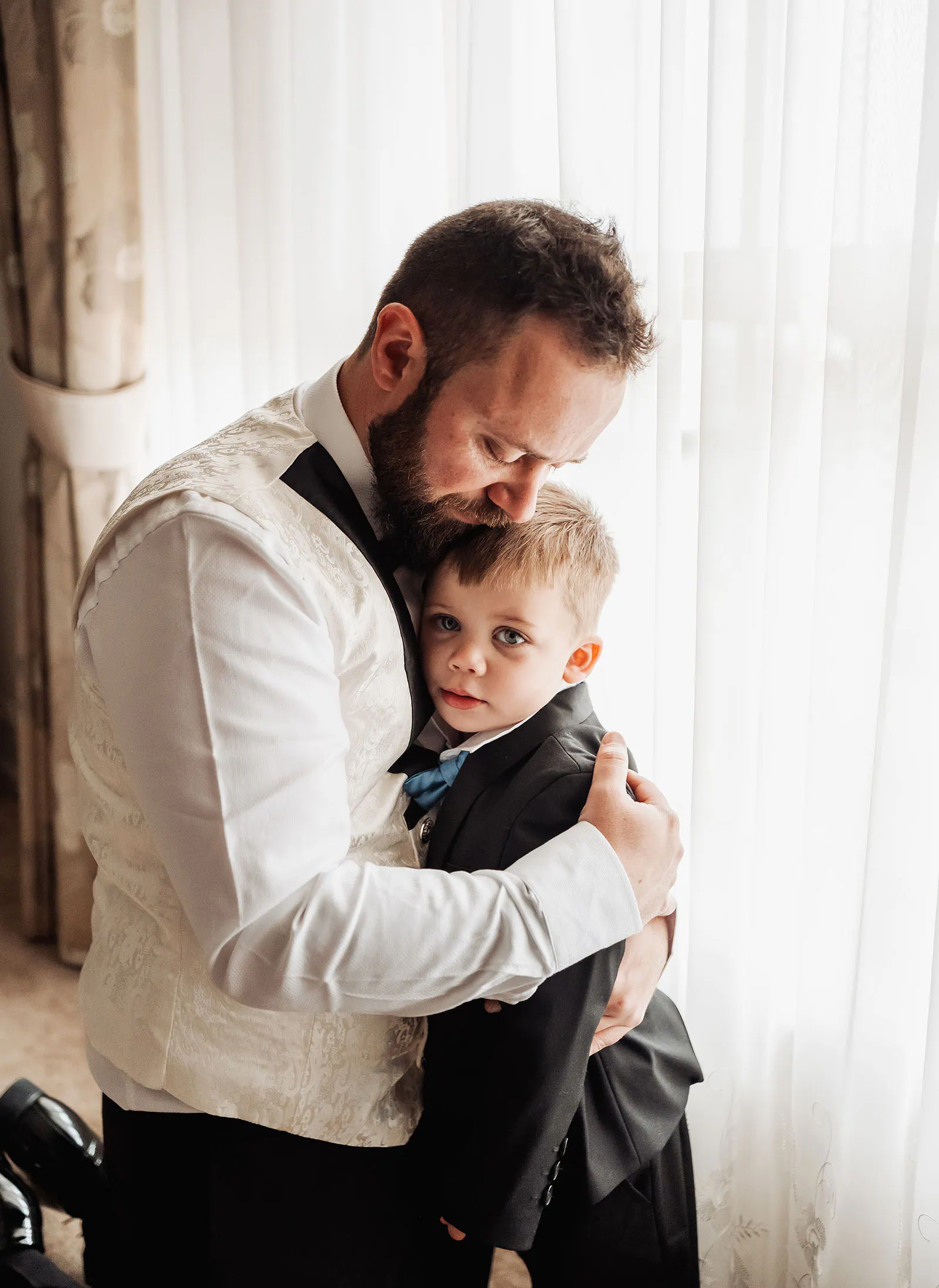 silvestris of clarendon wedding - sam & wayne 187 Father and son hugging in warm, joyful embrace.