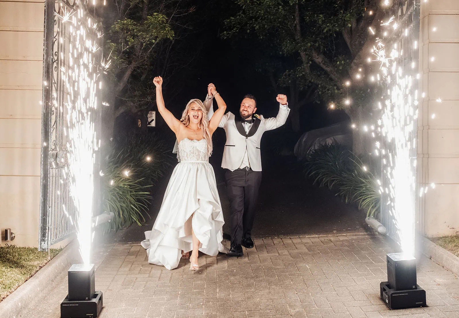 silvestris of clarendon wedding - sam & wayne 276 Bride and groom walk with fireworks illuminating their wedding night celebration.