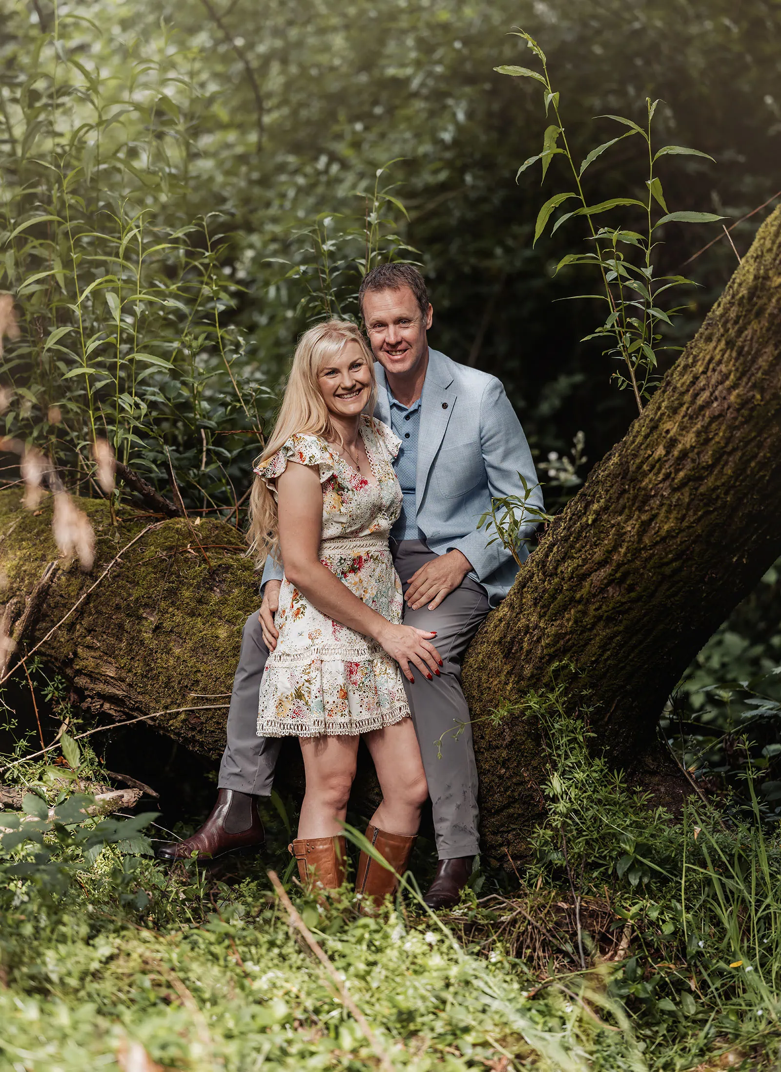ironbank family photography 115 Couple in colorful attire embracing nature in a lush, serene woodland setting.
