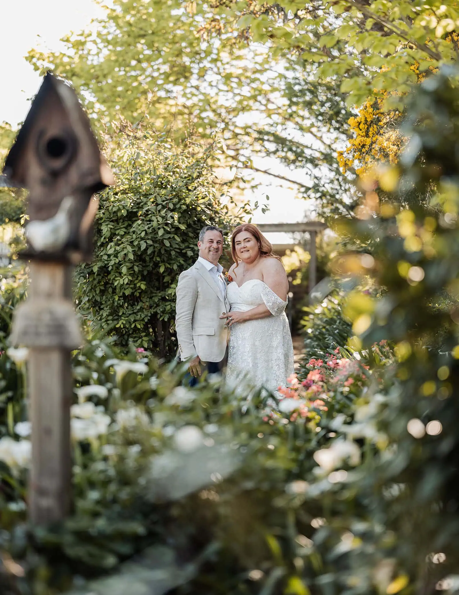 country victoria wedding in corrunnun – rachelle & anthony 340 Romantic couple in lush garden setting, embracing love and nature.