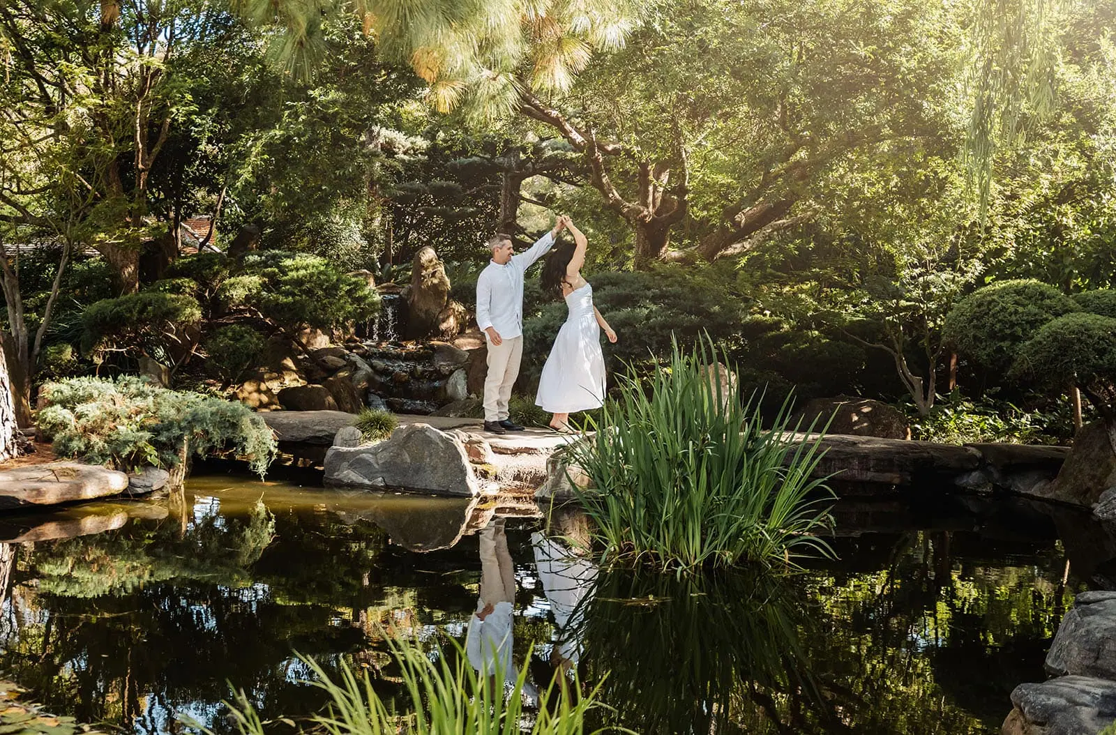 himeji gardens couples shoot - tom & tess 98 Couple dancing gracefully in a vibrant garden setting.