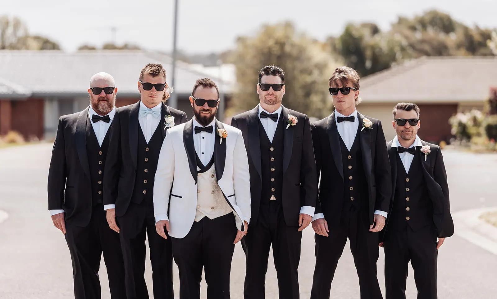 silvestris of clarendon wedding - sam & wayne 191 Groom with smiling groomsmen in matching suits at wedding celebration.