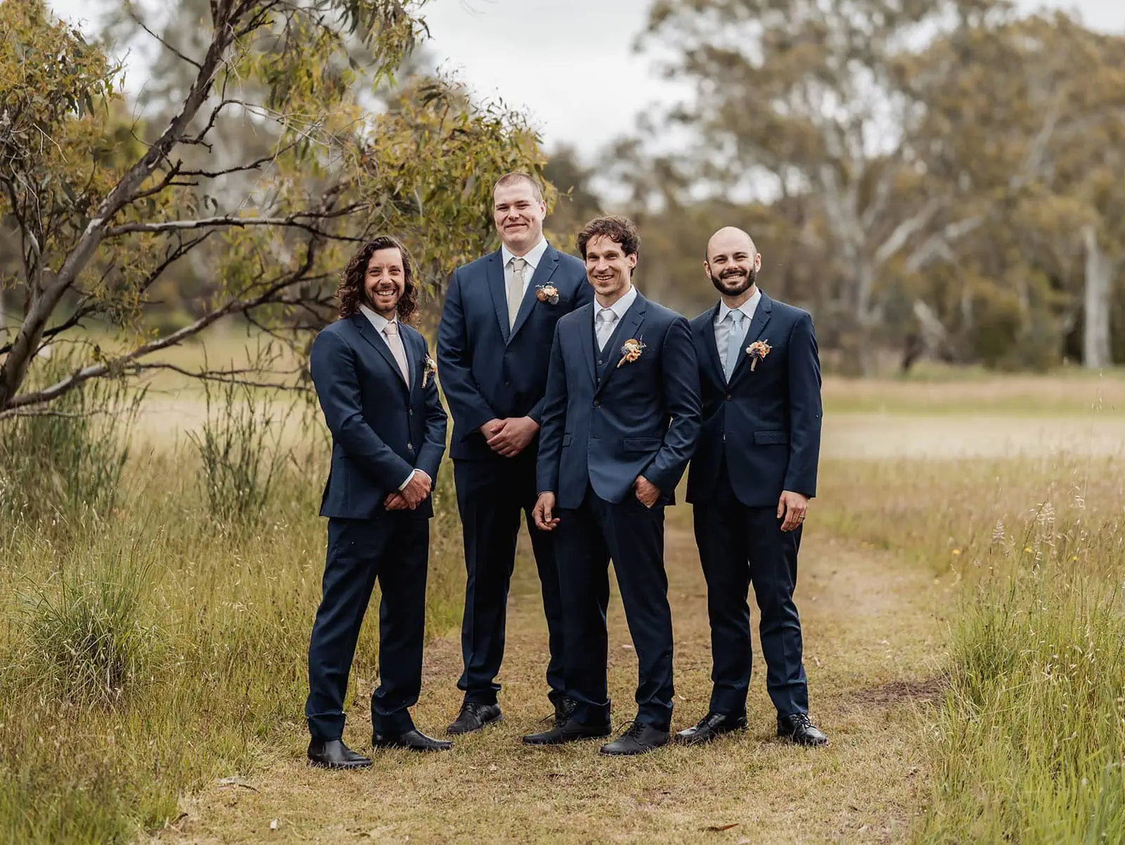 fleurieu cherries wedding - kimberley & richard 35 Groomsmen in suits pose outdoors, celebrating wedding day in scenic setting.