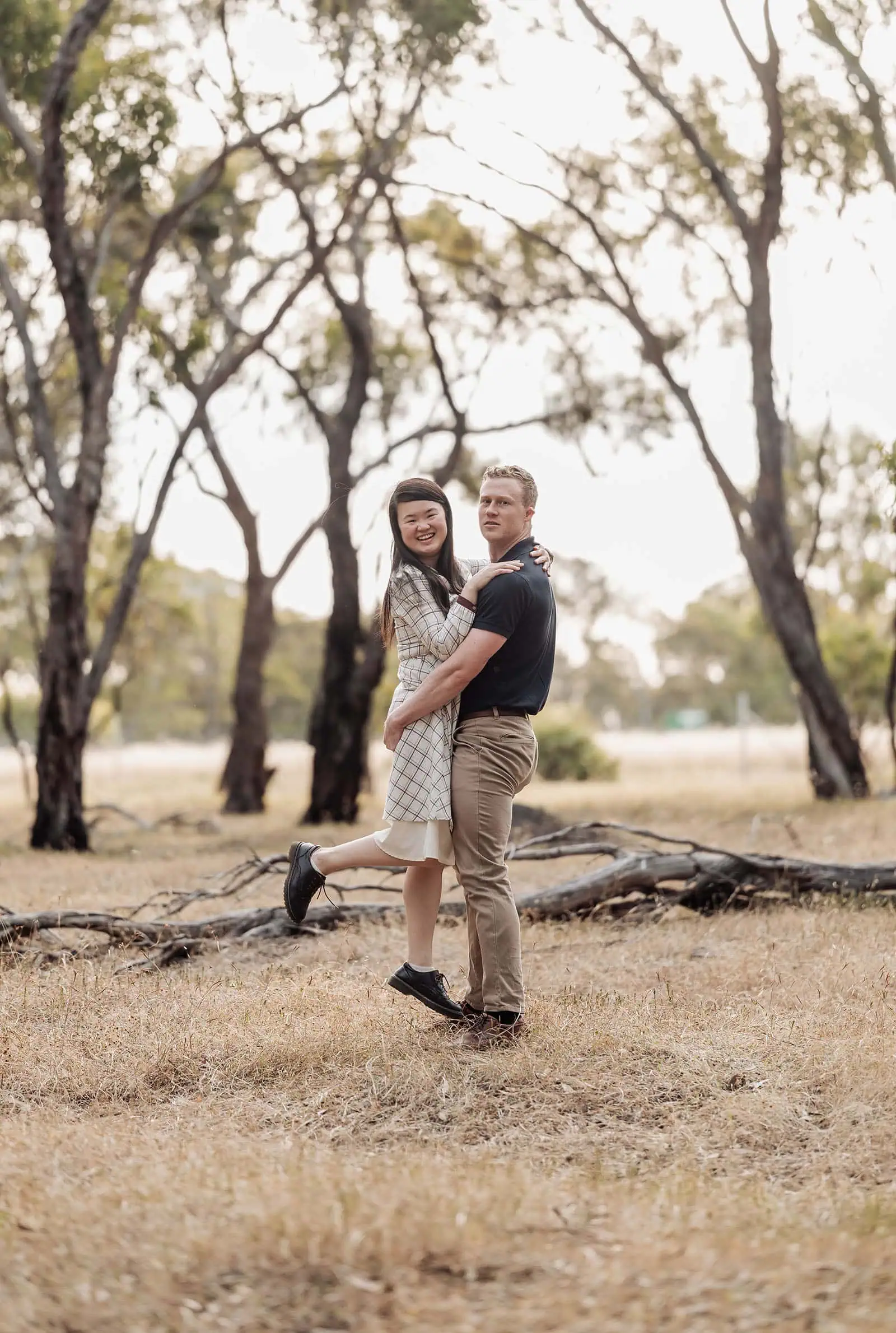 happy valley reservoir family shoot 89 Happy couple in woodland, man lifting woman, serene, joyful nature scene.
