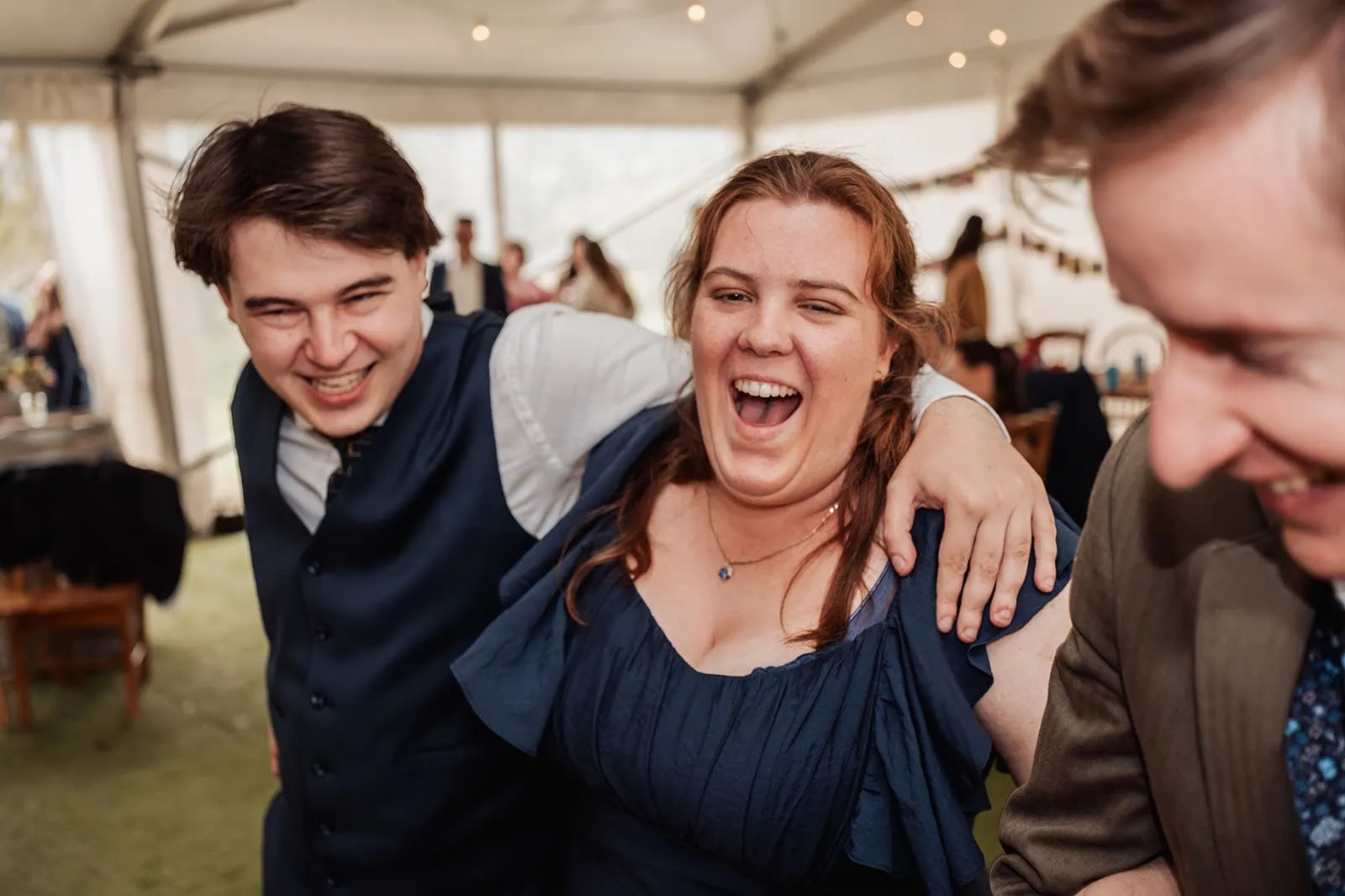 fleurieu cherries wedding - kimberley & richard 63 Party guests enjoying a joyful celebration with colorful decorations and laughter.