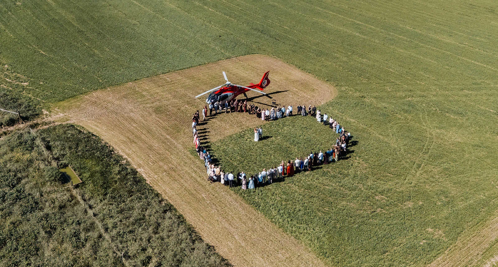 country victoria wedding in corrunnun – rachelle & anthony 329 Helicopter landing in open field during outdoor event under clear sky.