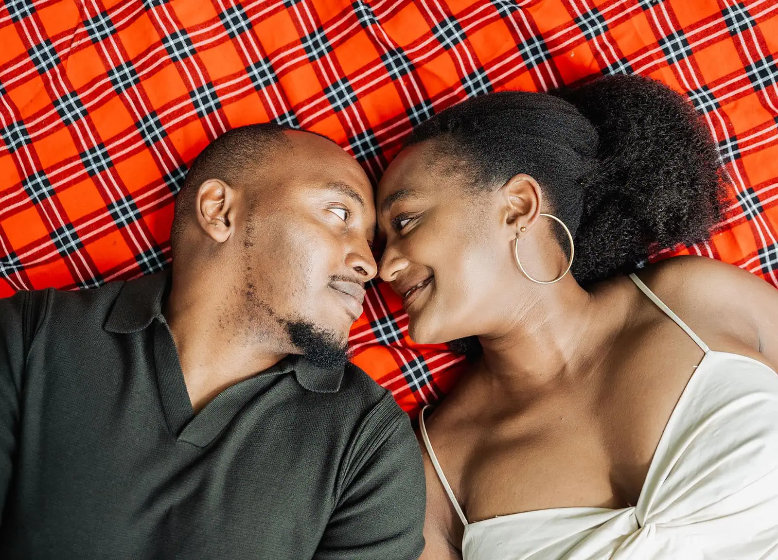 mt lofty botanic gardens couples shoot – ruth & emanuel 9 Couple embracing on a plaid blanket in a park.