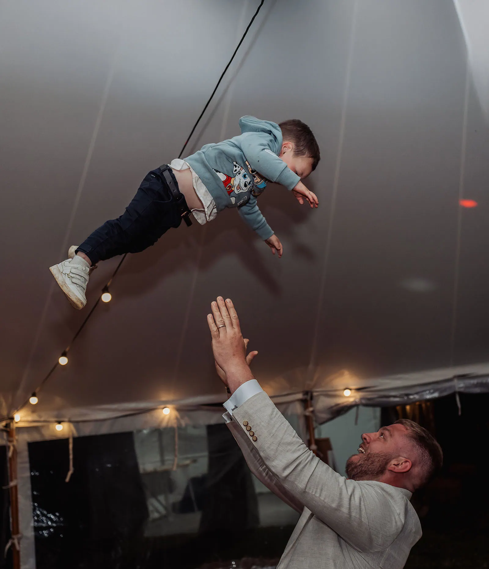 country victoria wedding in corrunnun – rachelle & anthony 379 A joyful catch in bright lights at night.