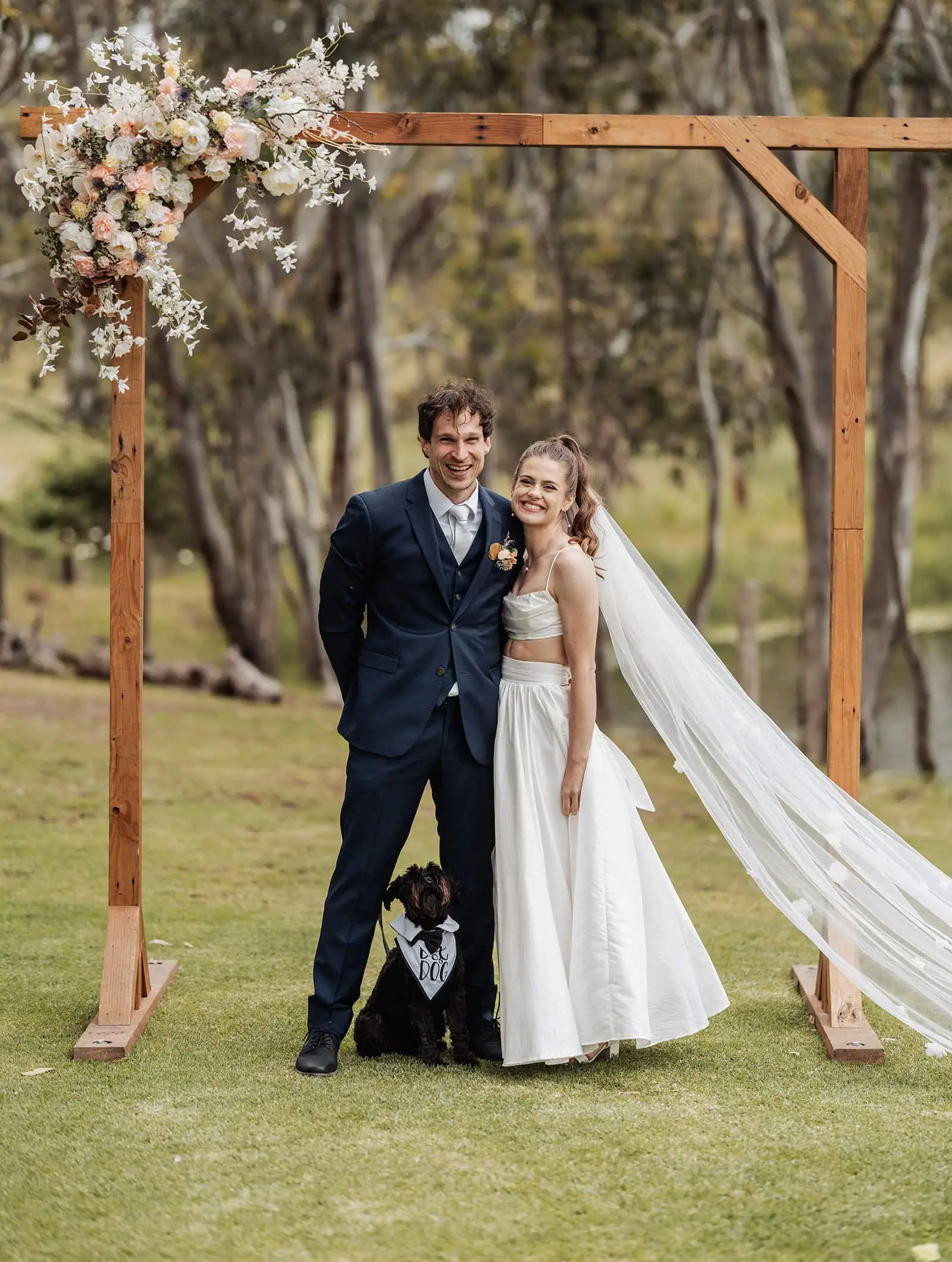 fleurieu cherries wedding - kimberley & richard 44 Happy couple under wedding arch in garden setting.