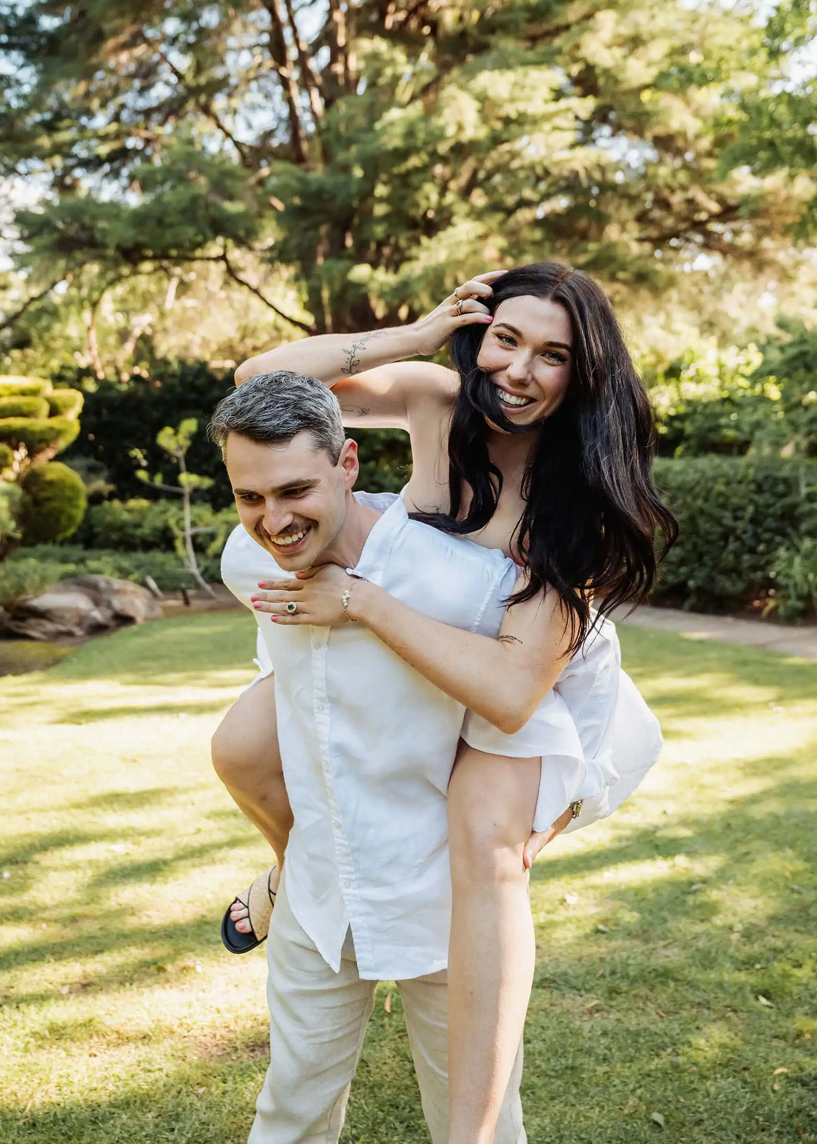 himeji gardens couples shoot - tom & tess 106 Garden joy with playful piggyback ride among flowers.