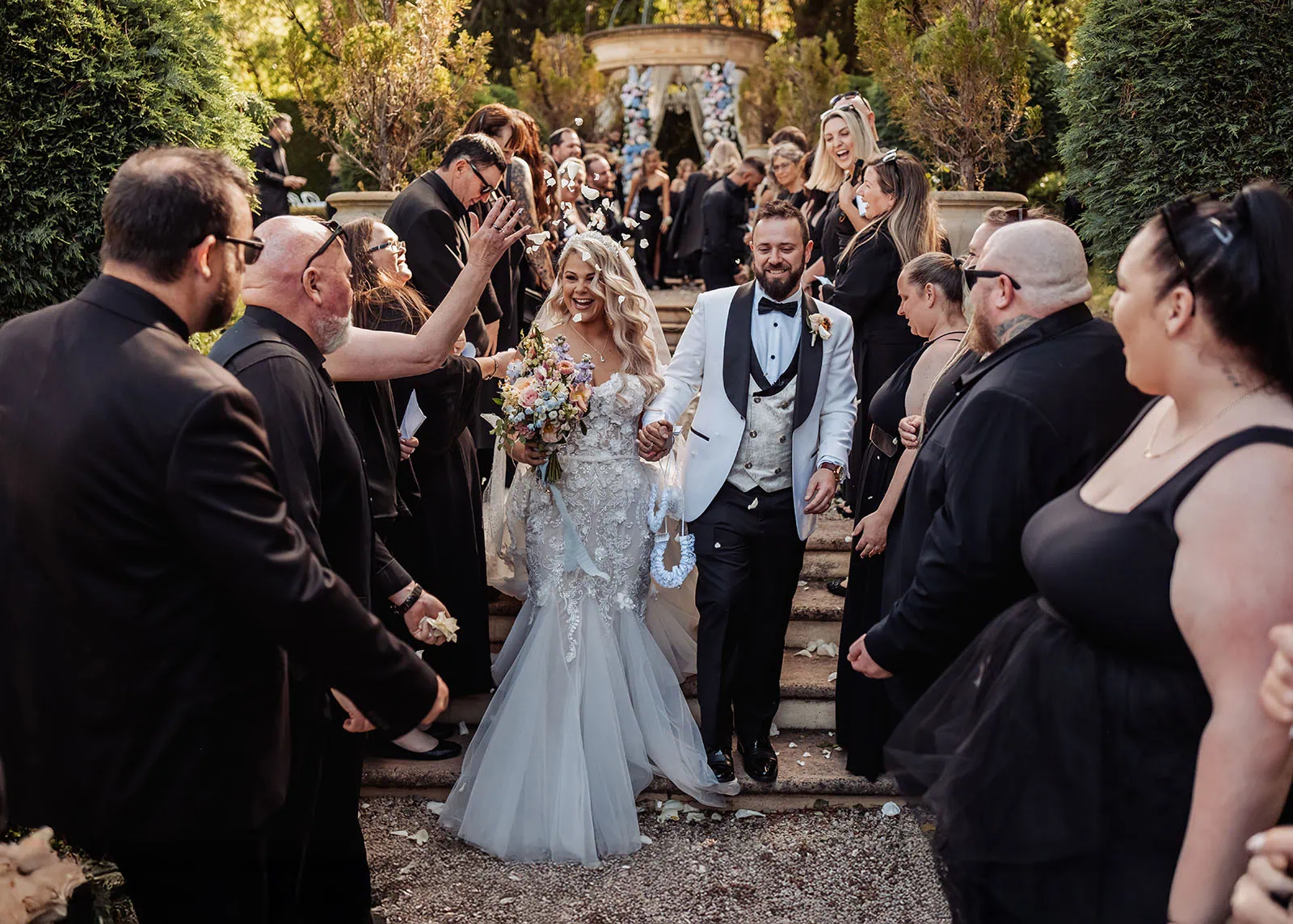 silvestris of clarendon wedding - sam & wayne 227 Joyful outdoor wedding ceremony with happy couple and guests celebrating.