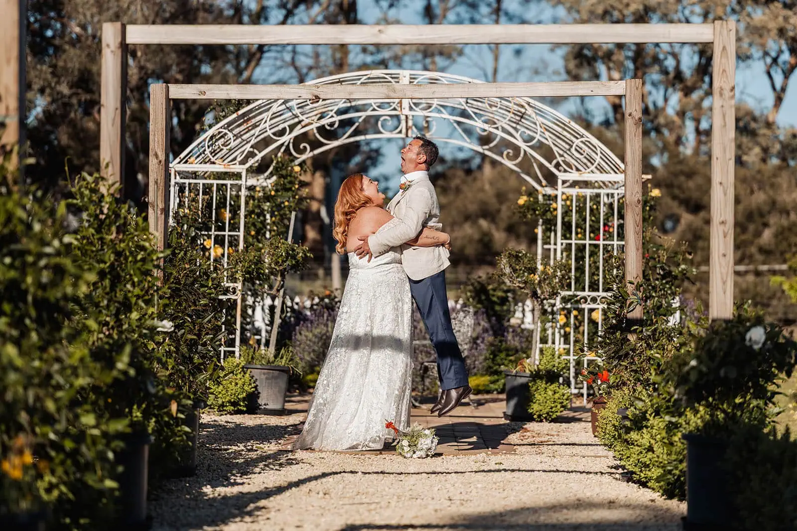 country victoria wedding in corrunnun – rachelle & anthony 351 Garden wedding celebration with joyful bride and groom under lush greenery.
