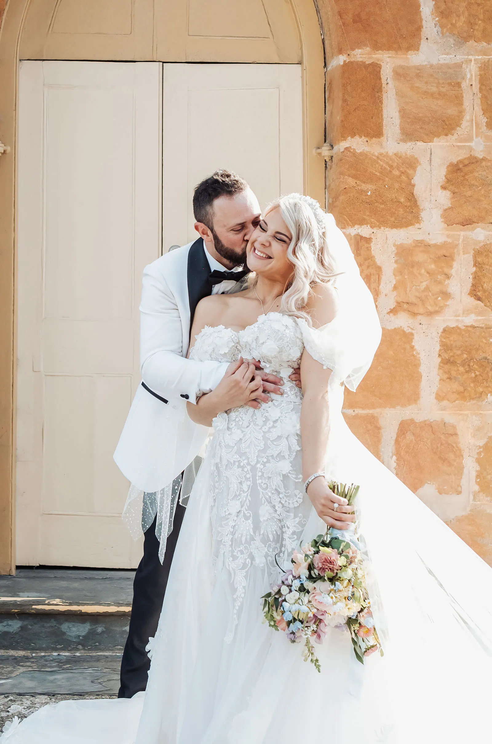 silvestris of clarendon wedding - sam & wayne 237 Newlywed couple in rustic setting, embracing happiness and love.