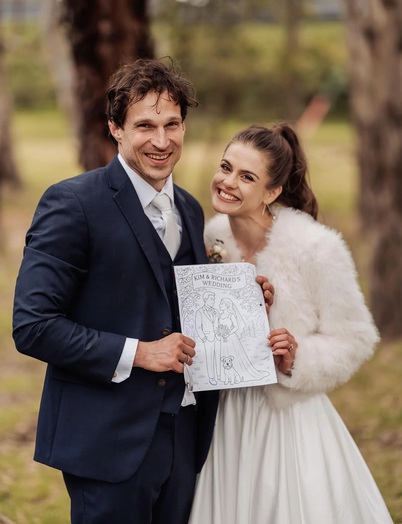 fleurieu cherries wedding - kimberley & richard 50 Newlywed couple smiling in sunny park setting, wedding attire, joyful moment captured.
