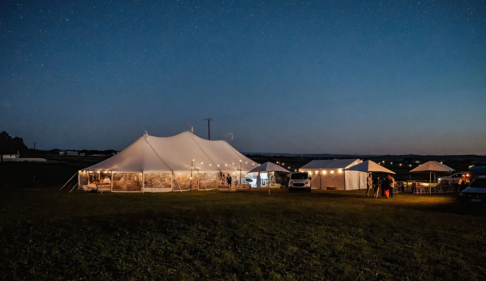 country victoria wedding in corrunnun – rachelle & anthony 367 Event at night with illuminated tents and vibrant atmosphere.