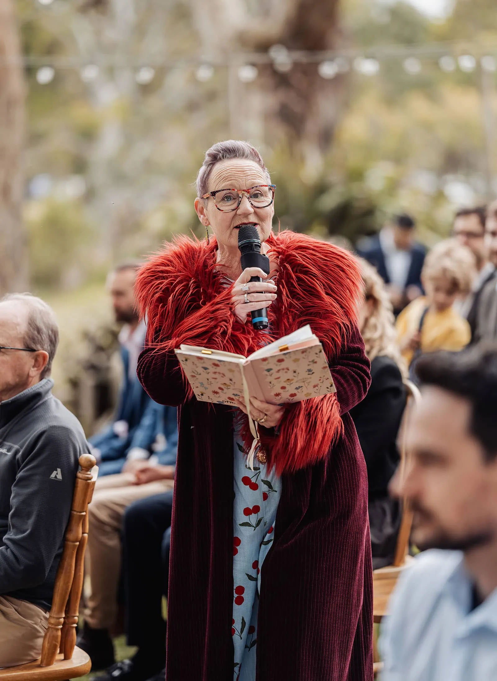 fleurieu cherries wedding - kimberley & richard 11 Outdoor event keynote speaker addressing a crowd under sunny skies.