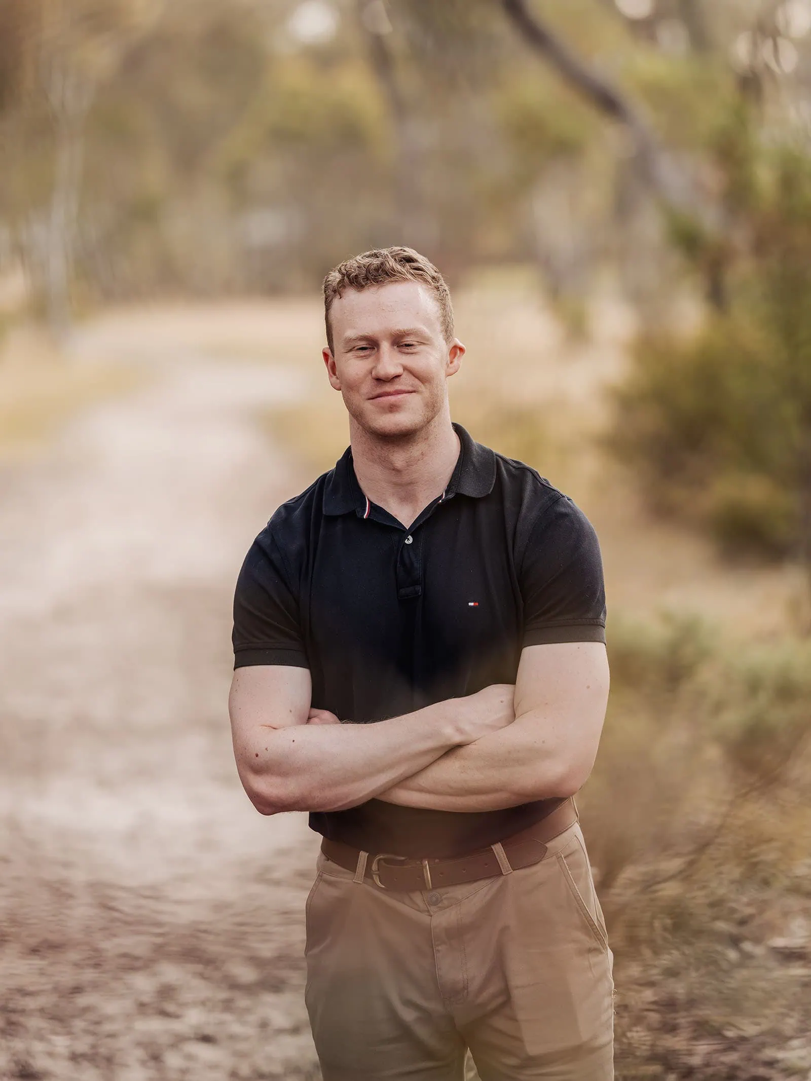 happy valley reservoir family shoot 98 Man standing on a nature path, relaxed in a casual outfit, surrounded by tranquil scenery.