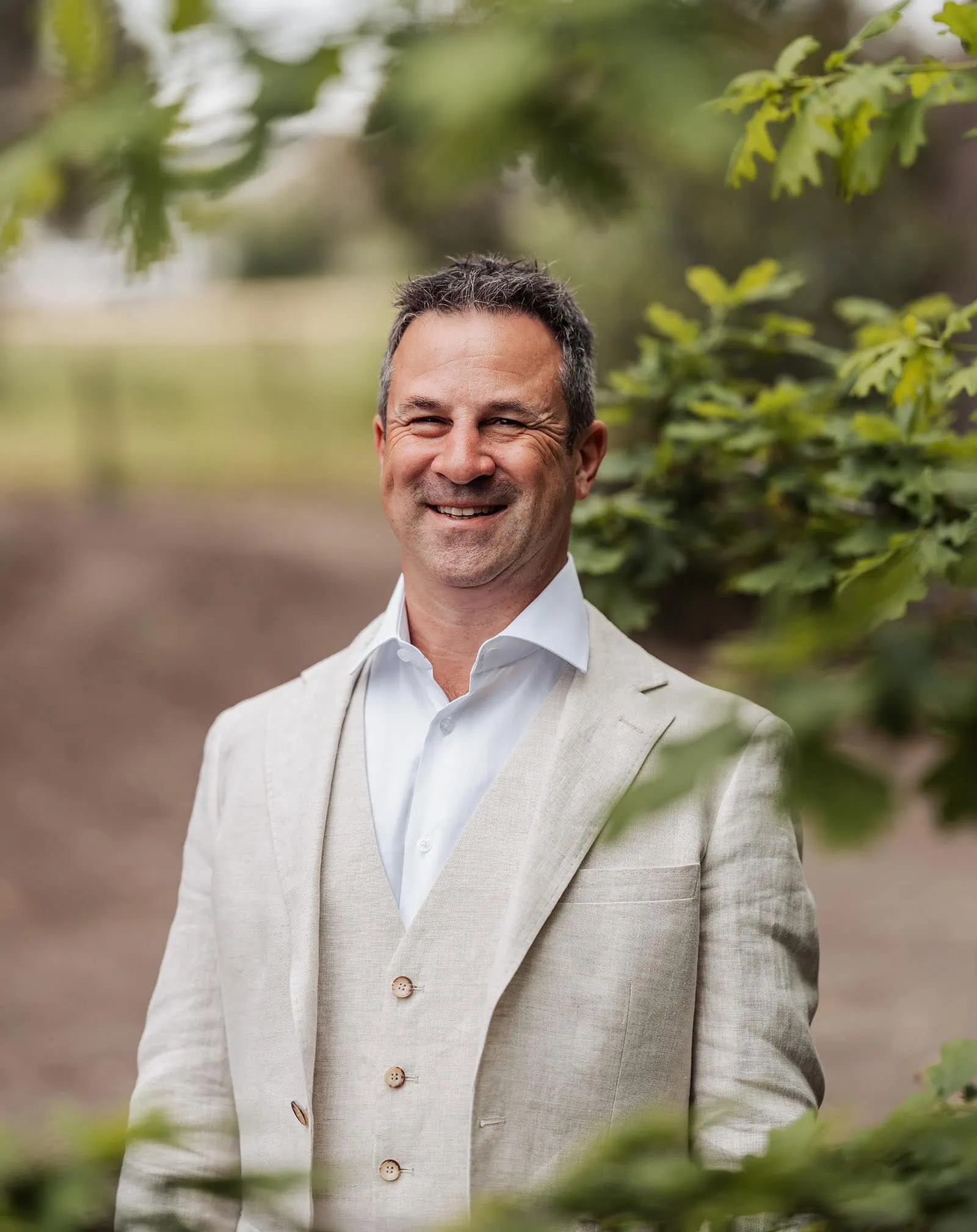 country victoria wedding in corrunnun – rachelle & anthony 286 Middle-aged man smiling outdoors in a natural setting.