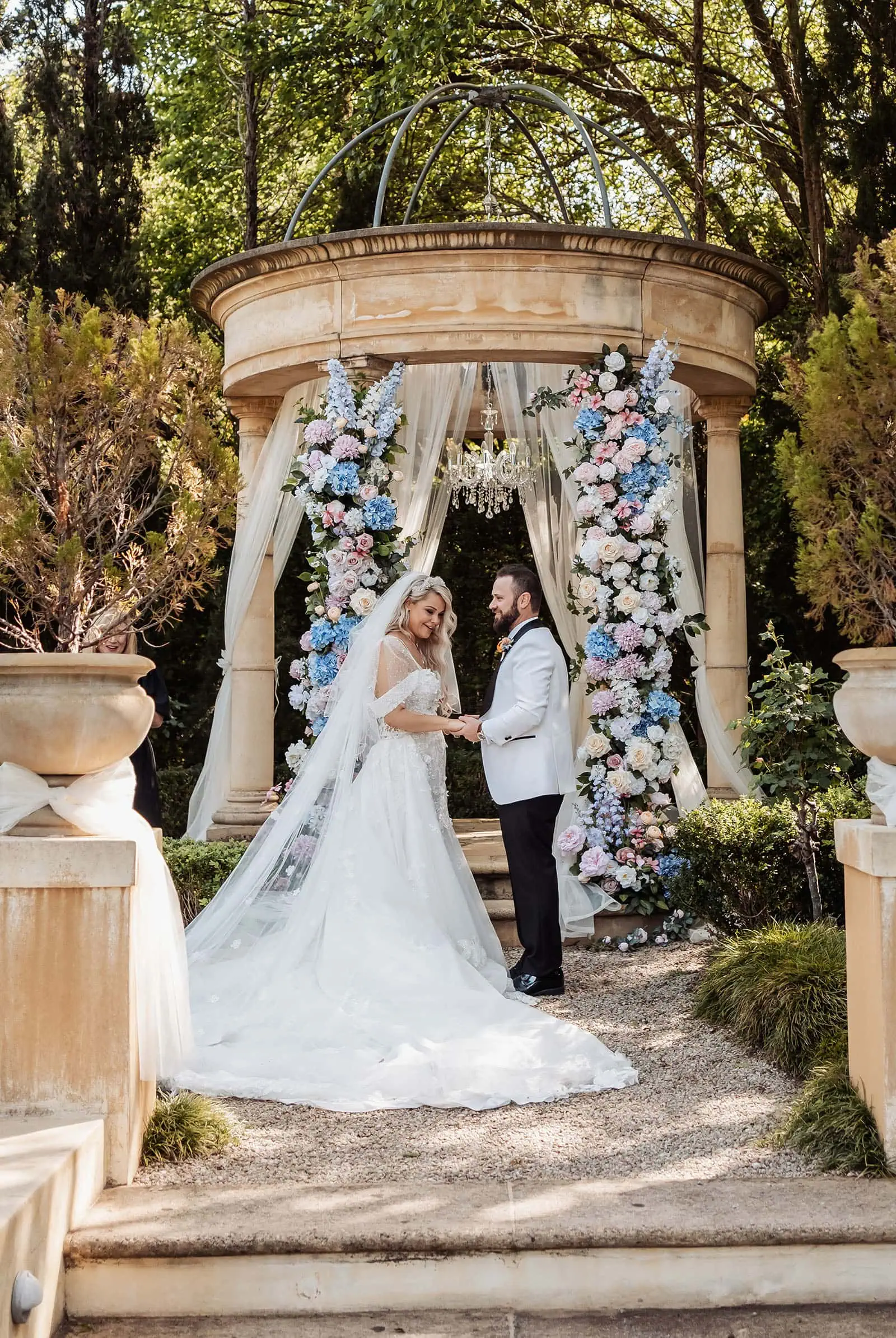 silvestris of clarendon wedding - sam & wayne 214 Romantic outdoor wedding setup with elegant decorations and natural scenery.