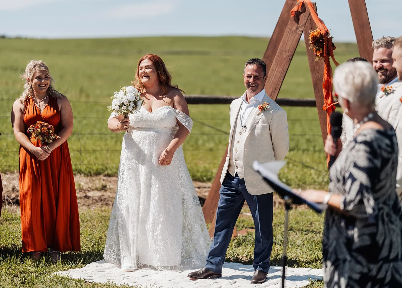 country victoria wedding in corrunnun – rachelle & anthony 320 Sunny outdoor wedding ceremony with elegant decorations and joyful guests.