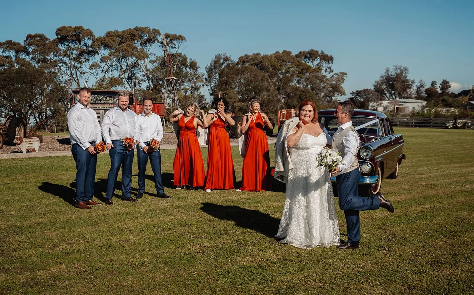 country victoria wedding in corrunnun – rachelle & anthony 344 Elegant outdoor wedding ceremony with flowers and guests enjoying a sunny celebration.
