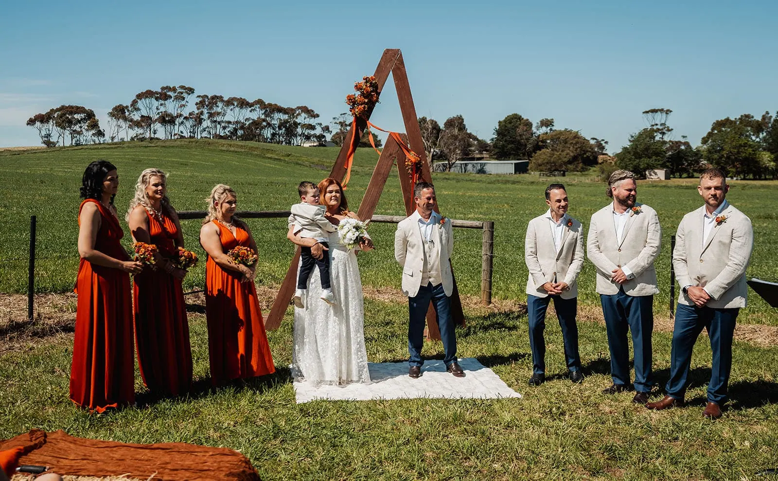 country victoria wedding in corrunnun – rachelle & anthony 322 Elegant outdoor wedding ceremony with floral decor and guests seated.