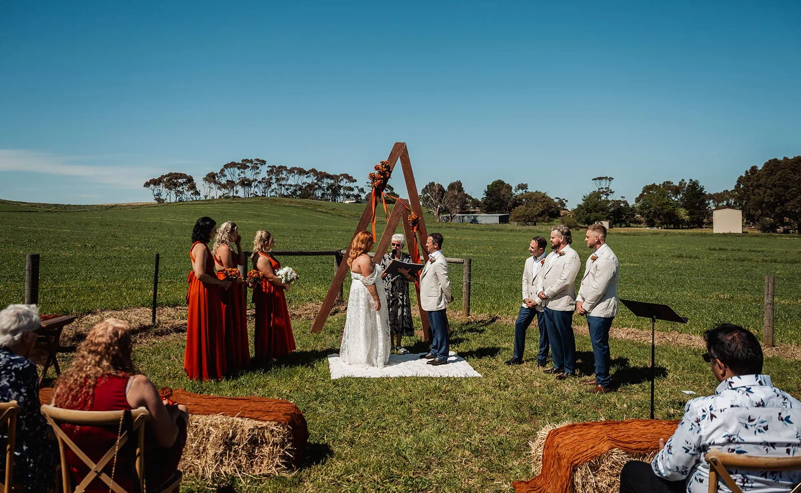 country victoria wedding in corrunnun – rachelle & anthony 323 Elegant outdoor wedding ceremony under sunny skies.