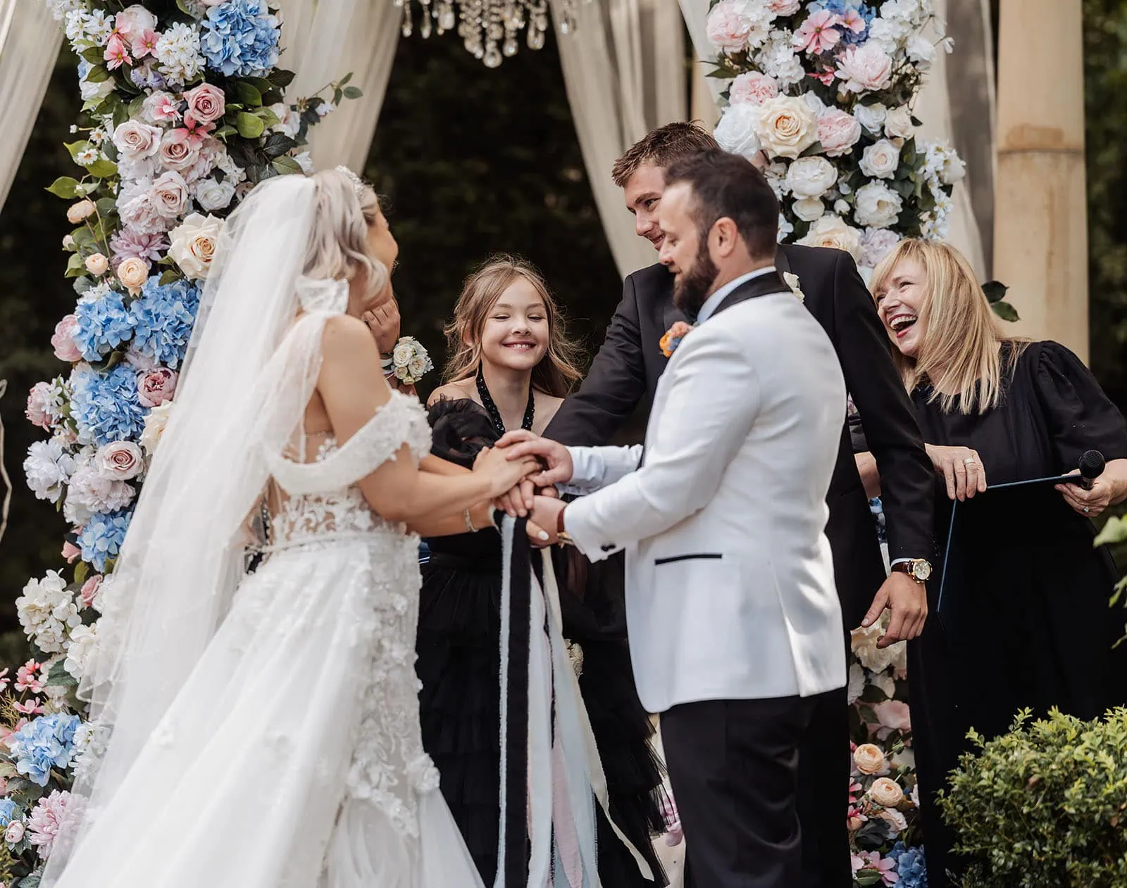 silvestris of clarendon wedding - sam & wayne 221 Elegant outdoor wedding ceremony with floral decorations and guests seated.
