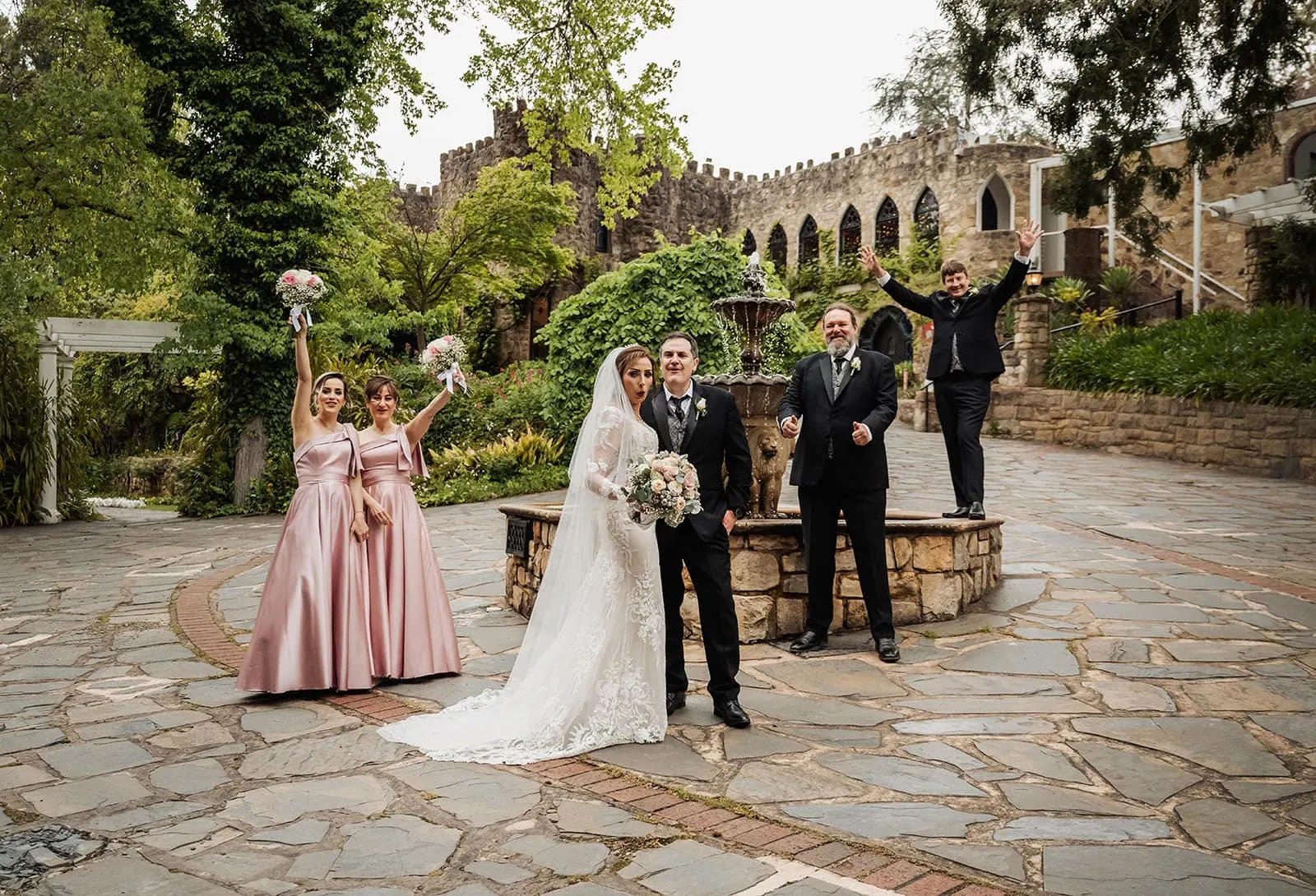 wedding at the manor in basket range - maryam & jason 156 Outdoor wedding ceremony with floral decorations and guests seated under a sunny sky.