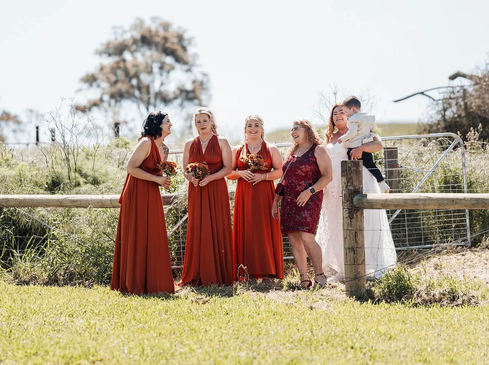 country victoria wedding in corrunnun – rachelle & anthony 315 Scenic outdoor wedding ceremony under sunny skies with elegant floral arrangements.
