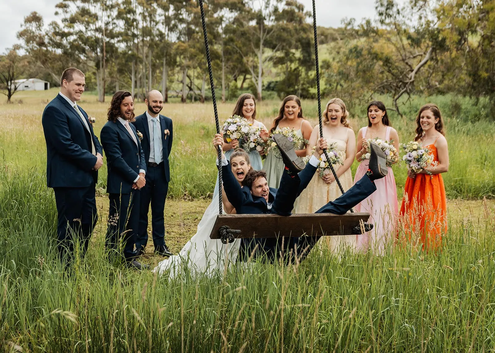 fleurieu cherries wedding - kimberley & richard 25 Bride and groom enjoy a joyful swing ride at their outdoor wedding.