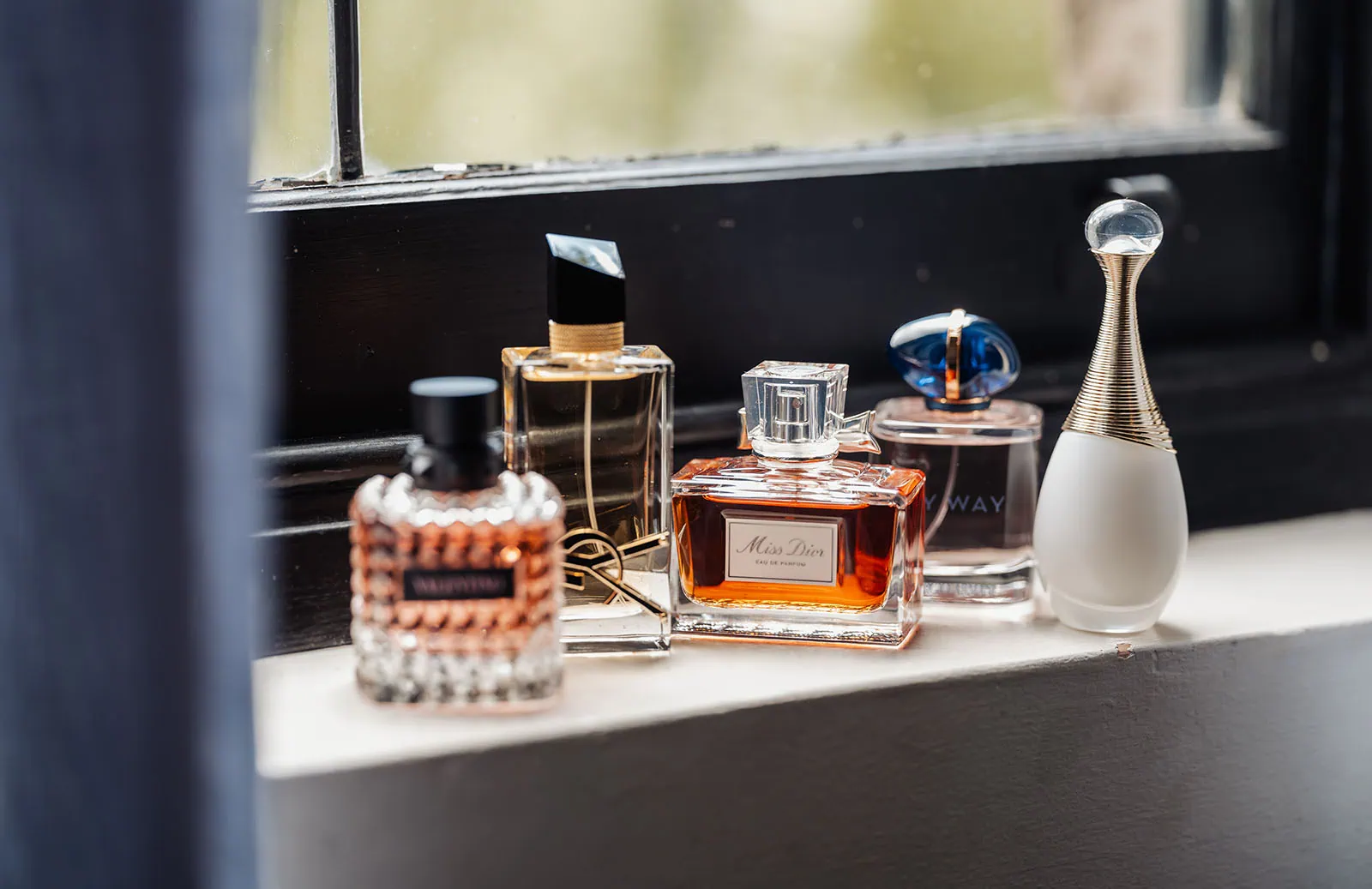 wedding at the manor in basket range - maryam & jason 123 Elegant perfume bottles in assorted shapes, sizes, and colors.