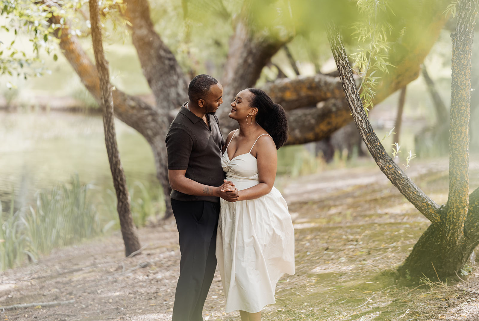 mt lofty botanic gardens couples shoot – ruth & emanuel 13 Romantic couple embracing in scenic nature setting under clear skies.