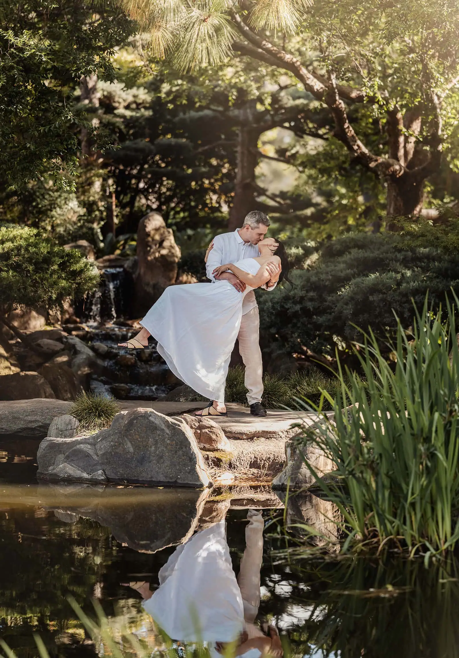 himeji gardens couples shoot - tom & tess 96 Couple enjoying a romantic moment in a lush garden setting.