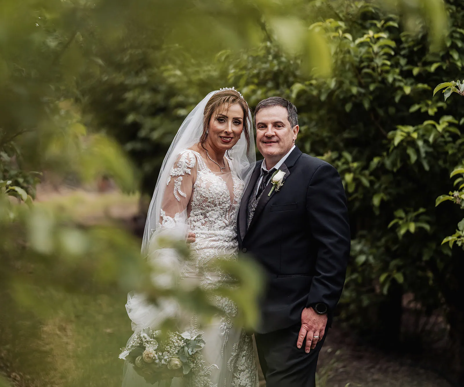 wedding at the manor in basket range - maryam & jason 161 Intimate wedding scene with bride and groom exchanging vows outdoors.