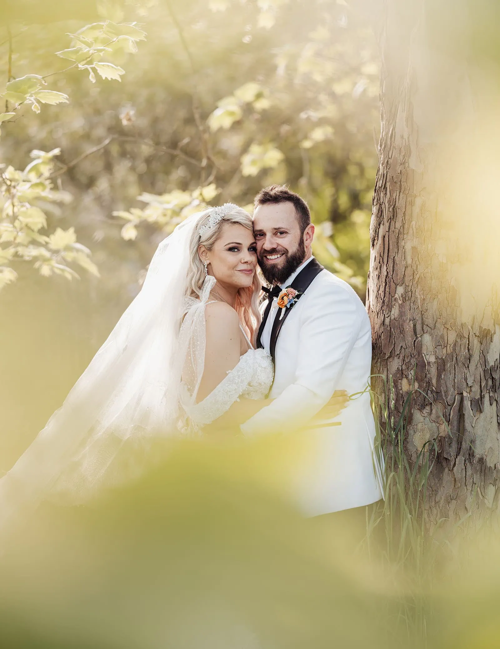 silvestris of clarendon wedding - sam & wayne 241 Bride and groom embrace under soft sunset light during wedding ceremony.