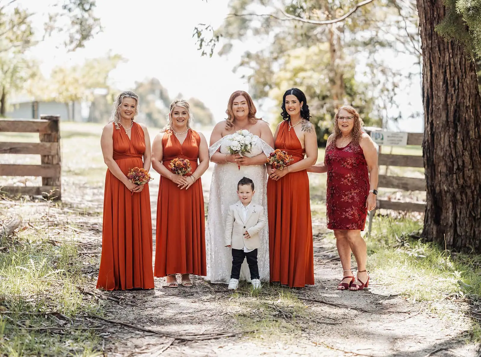 country victoria wedding in corrunnun – rachelle & anthony 308 Rustic outdoor wedding with guests, farmhouse backdrop, and floral decorations.