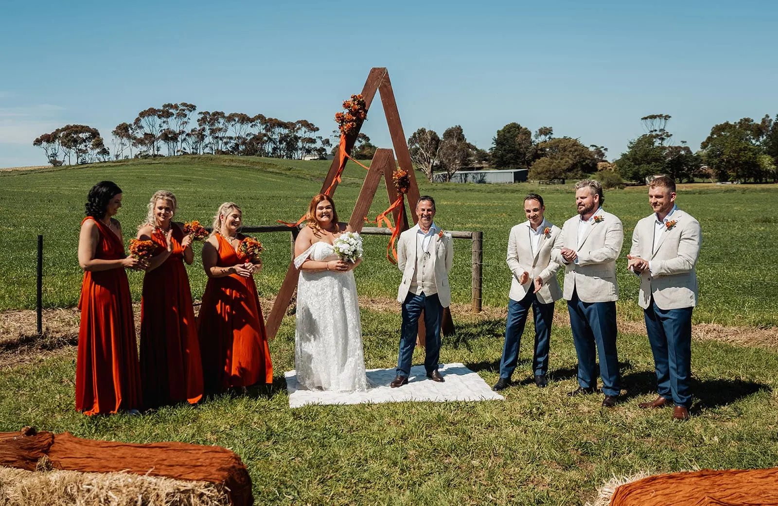 country victoria wedding in corrunnun – rachelle & anthony 319 Rustic outdoor wedding setup with wooden chairs and floral decorations in a natural setting.