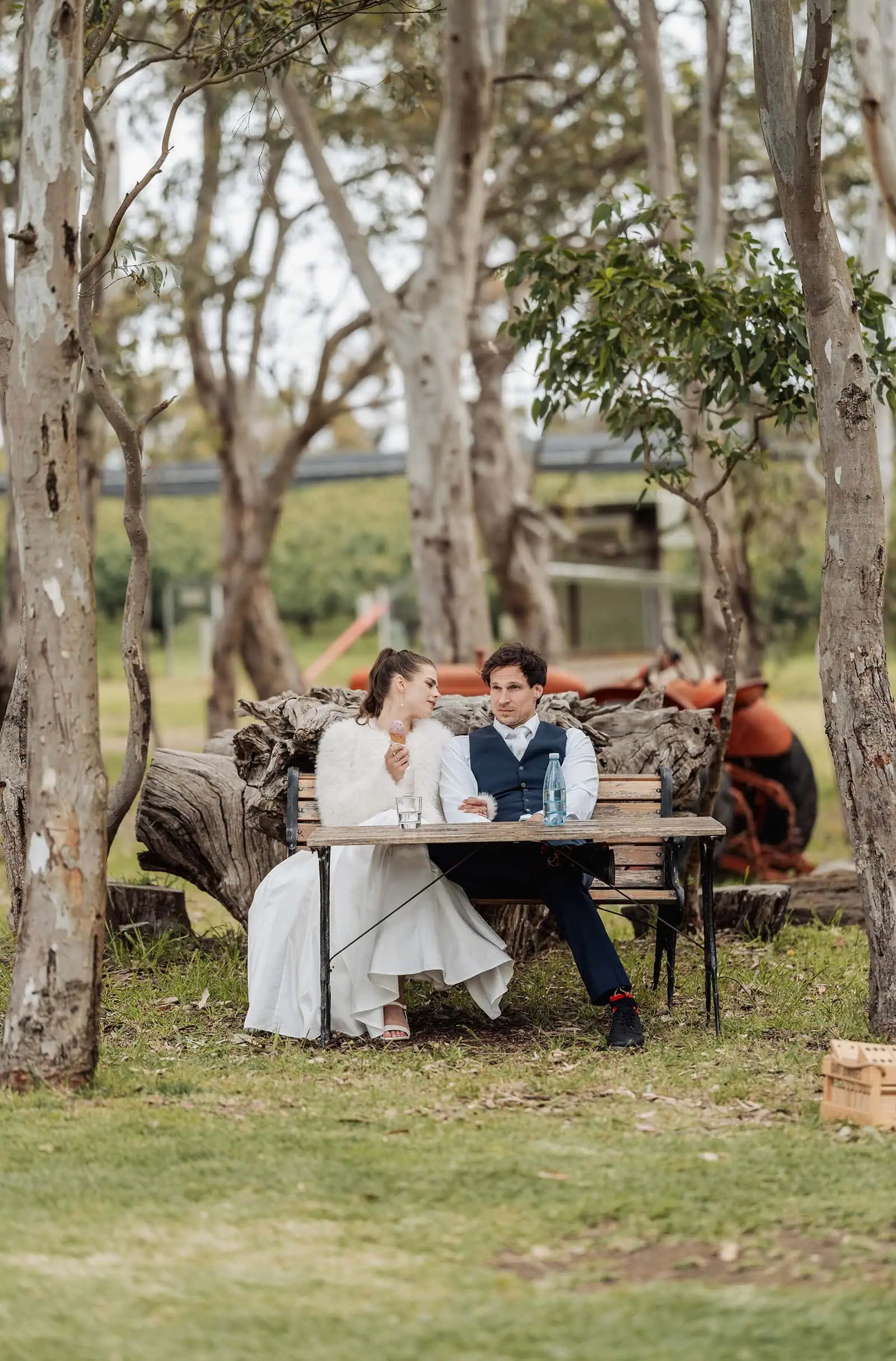 fleurieu cherries wedding - kimberley & richard 58 Couple enjoying tranquil garden moment amidst lush greenery.