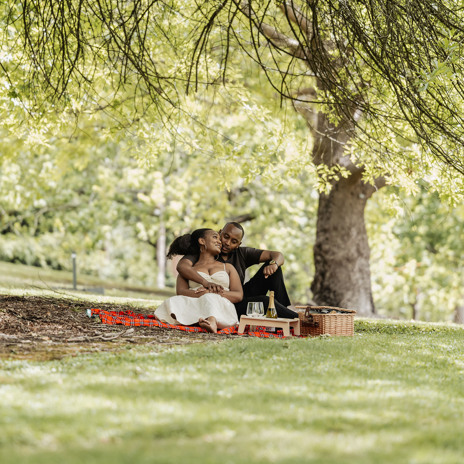mt lofty botanic gardens couples shoot – ruth & emanuel 1 Couple enjoying a peaceful picnic in a scenic outdoor setting.
