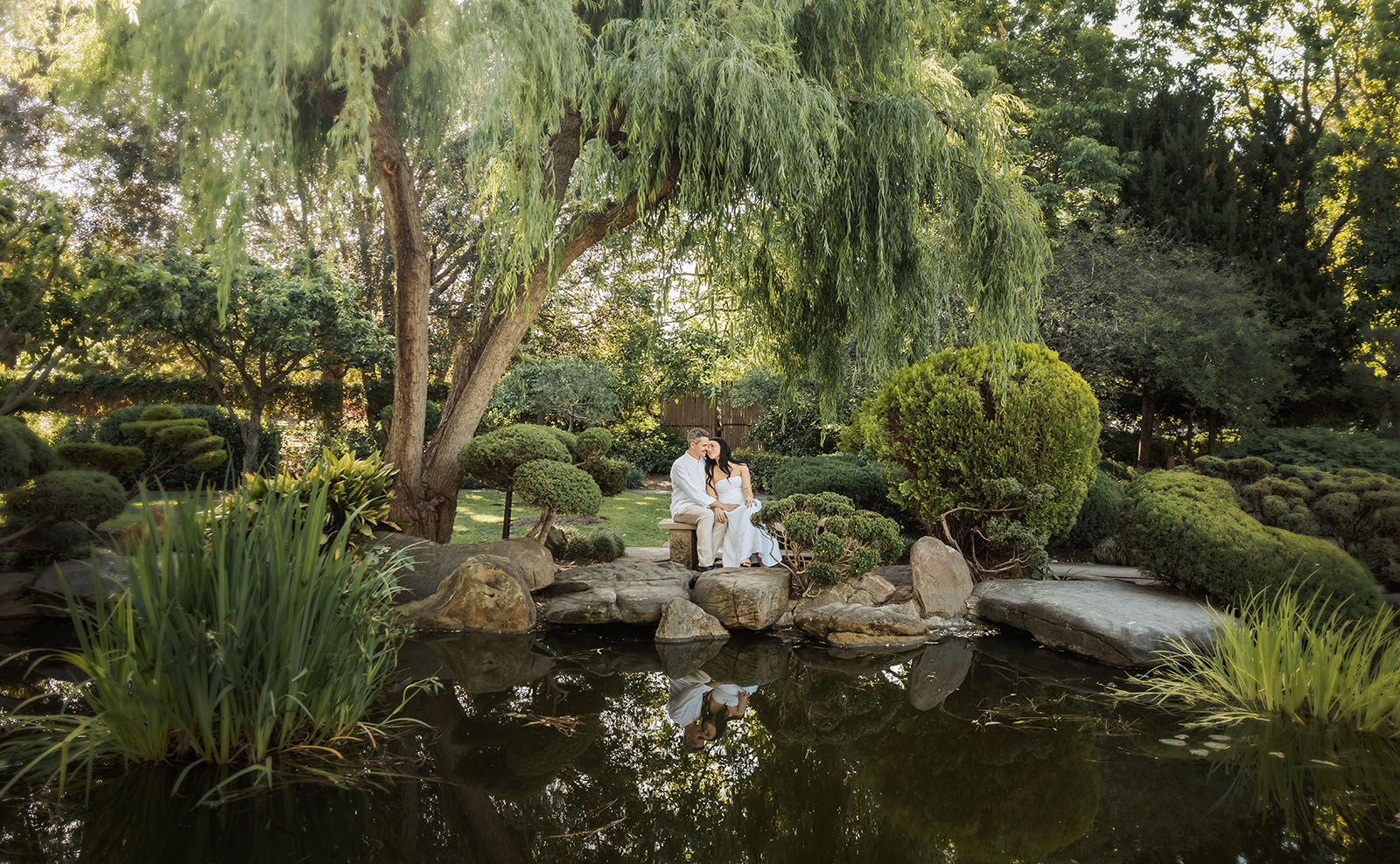 himeji gardens couples shoot - tom & tess 91 Couple enjoying a peaceful garden setting with lush greenery.