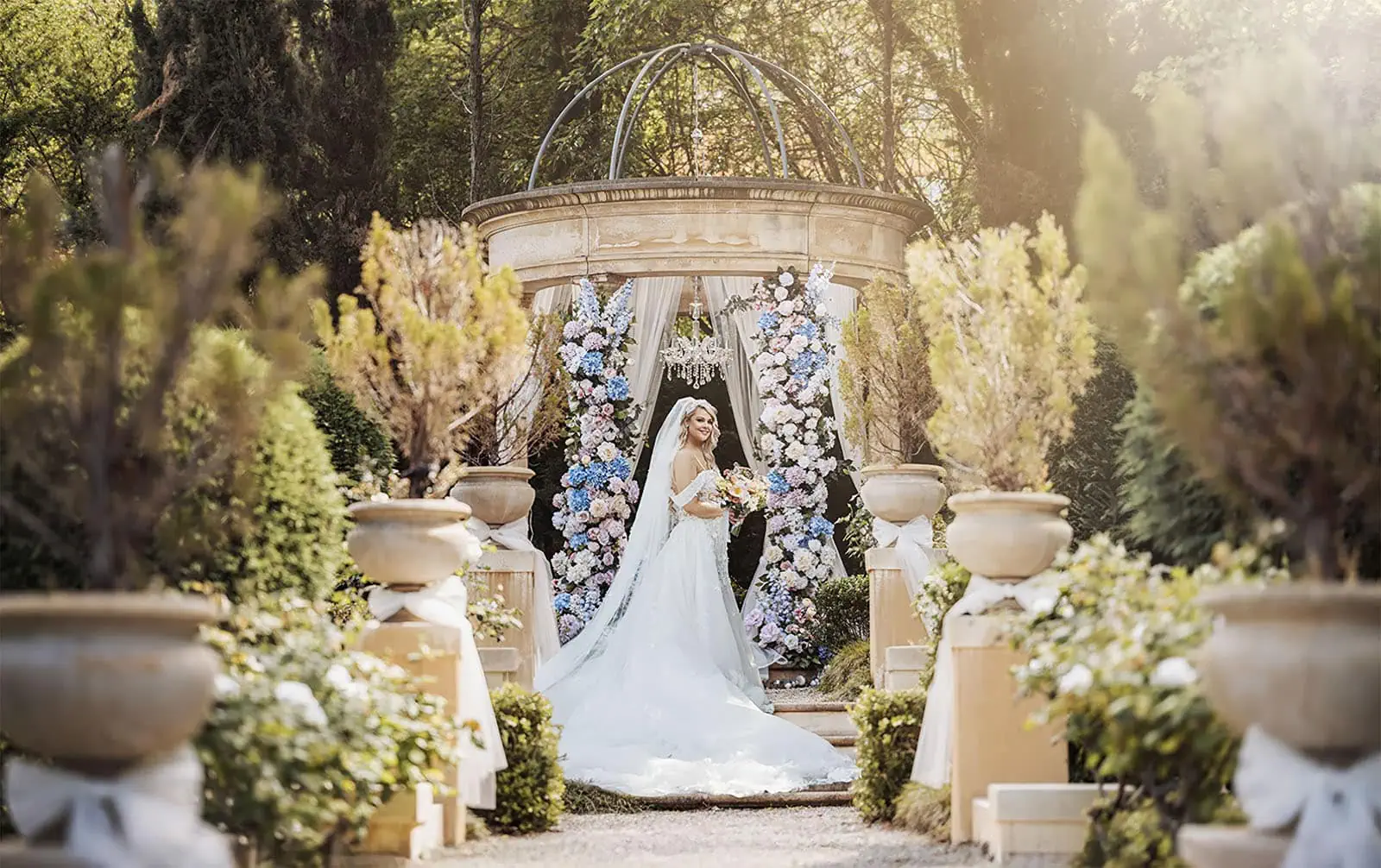 silvestris of clarendon wedding - sam & wayne 233 Elegant garden wedding scene with lush greenery and romantic decorations.
